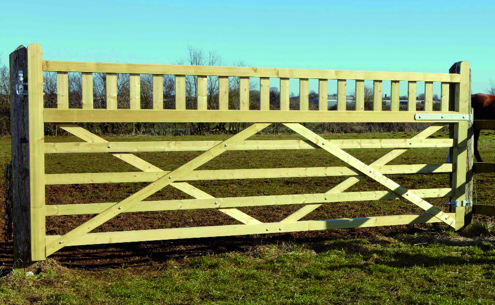 A sturdy entrance gate in a brown finish providing a welcoming entrance to a secluded property